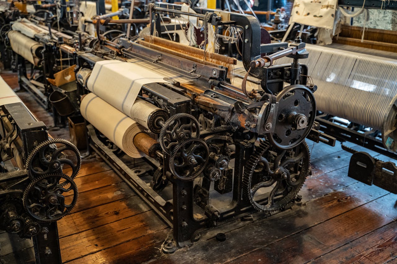 Explore the intricate mechanics of a vintage textile loom in a historic Polish factory setting.
